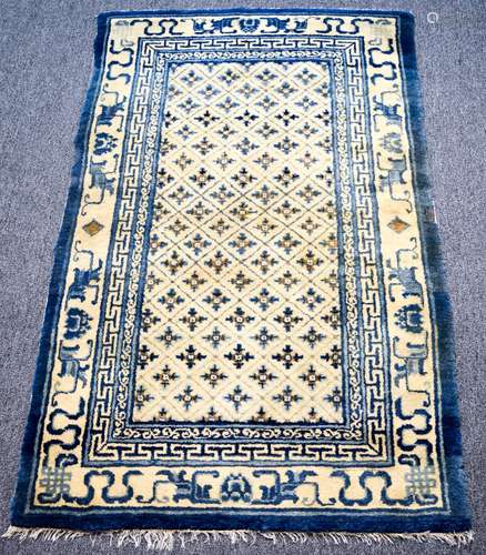 Mid 19th century Chinese carpet with blue and ivory decoration. Some reweave-small areas. Staining. Good pile. 41