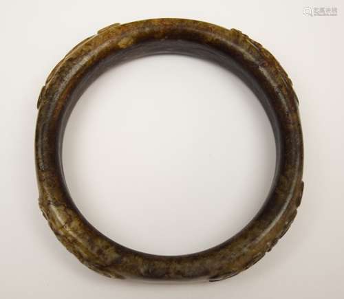 Jade bracelet. China. Ming period. Black and grey stone. Surface carved with clouds and mythical animals. 3