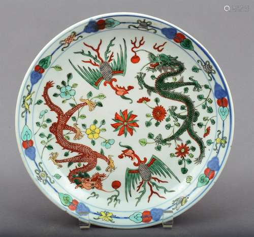 Porcelain plate. China. Late Ming period. Wu Tsai ware. Underglaze blue with over glaze enamels. Decoration of dragons, phoenixes and flowers.  Borders of ju-I and the 