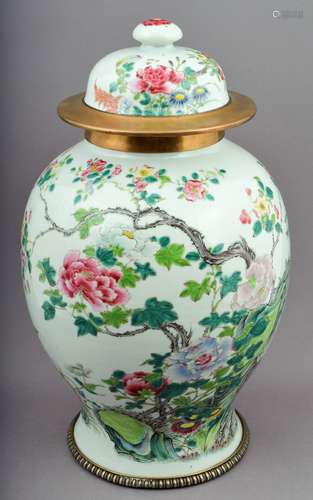 Covered jar. China. 19th century. Baluster form. Famille Rose decoration
of butterflies and flowers.