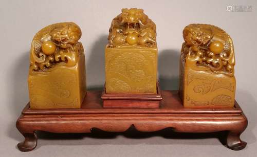 Lot of three Soapstone seals. China. 20th century. Honey colored stones. Carved dragon finials. Each- 3-1/2