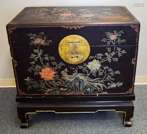 Lacquered Chest. China. 18th century. Heavy wood with surface lacquered in polychrome and gilt with various flowering plants within archaic borders. Heavy gilt bronze mounts engraved with dragons phoenixes (surface stains and rough edges). 35