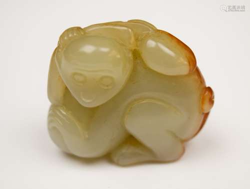 Jade carving. China. 19th century. Grey stone with an area of russet. Study of a monkey with peaches. 2