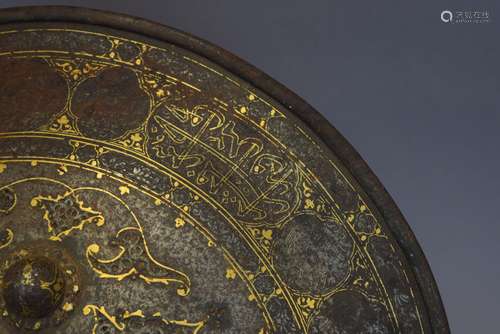 Shield. Persia. 19th century. Steel with gold inlay of arabesques and calligraphy.