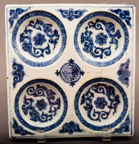 Porcelain dish. Korea. 18th cent. Square form with saucer depressions. Underglaze blue decoration of scrolling dragons and bats around a central shou medallion. 7-3/4