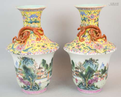 Pair of porcelain vases. Early 20th century. Upper register decorated with gilt iron red and gilt molded dragons on a floral scrolled yellow ground. Lower register with a Famille Rose landscape. Tao Kuang mark on the base. 11