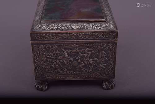 Chinese Export silver box. 19th century. Top and base inset with large agate plaques, repousse decoration of warriors in foliated reserves on a ground of birds and flowers. Borders of grape vines and acorn and oak leaves. Shield at the front. Avian feet. Signed HHC, see the Chait Collection, page 56. 6