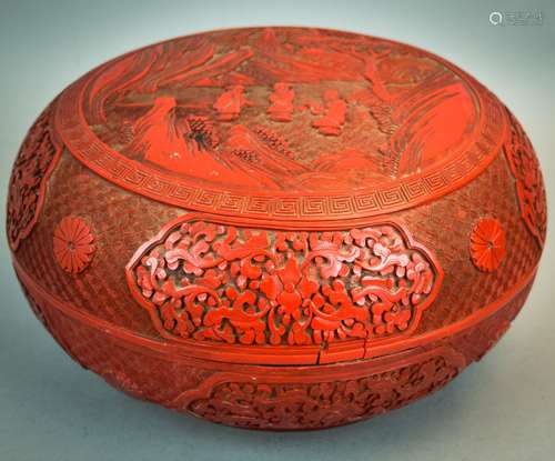 Cinnabar box. China. 18th/19th century. Round shape. Central decoration of a scholar with attendants in a landscape. Sides decorated with floral reserves all done on various diaper pattern ground. 10-1/2