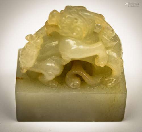 Jade carving. China. Yuan to early Ming. Stone of a green grey colour with a russet marking. Seal with a dragon finial. Seal intact. 1-1/2