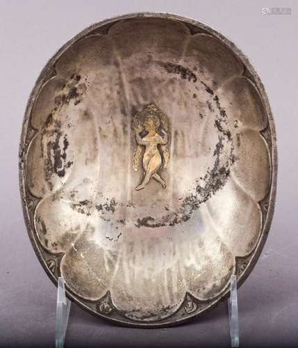 Silver gilt bowl. Sassanian period. Circa 7th century A.D. Central figure of a dancing woman. Reverse with human heads and flowers. 7