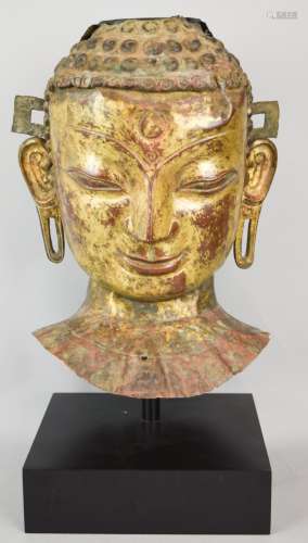 Repousse copper head of the Buddha. Tibet. 18th cent. Traces of gilt remaining. 17