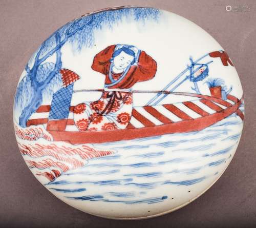 Seal paste box. China. 19th century. Underglaze blue and red decoration of a woman in a boat. Six character K'ang hsi mark on the base. 5-1/2