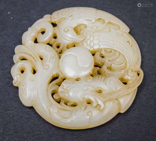 Jade carving. China. 18th century. Grey white stone. Circular carving of a dragon and phoenix. 2