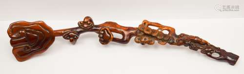 Horn brush rest. China. 19th century. Carved in the form of a ju-I scepter with ling chih. Deep amber patina. 8
