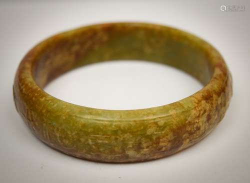 Jade bracelet. China. 18th cent.  Or earlier. Onion skin coloured stone. Surface carved archaic characters. 3-1/4