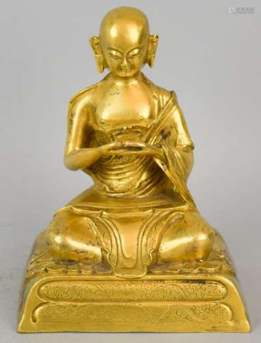 Gilt bronze Buddhist figure. Tibet. 18th century. Seated figure of a High Lama. Floral engraved surfaces. 6