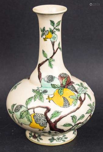 Porcelain vase. China. Late 19th century. Bottle shaped. San Tsai decoration of fruiting and flowering pomegranate trees in aubergine, green and yellow. K'ang hsi mark on the base. 6-1/2