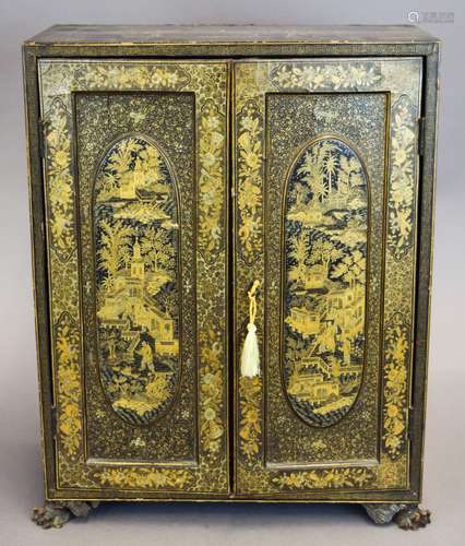 19th century Chinese Export lacquered small table top cabinet with gilt scenic decoration and carved paw feet. Two doors revealing a six draw interior. Some crazing and lifting to lacquer. 19