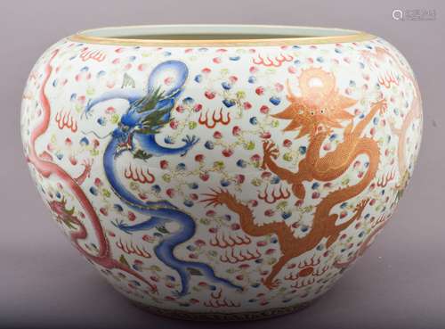 Large fish bowl. China. Late 19th century. Begging bowl form. Famille Rose enamel decoration of dragons and clouds. Tao Kuang mark on the base. 17-1/2