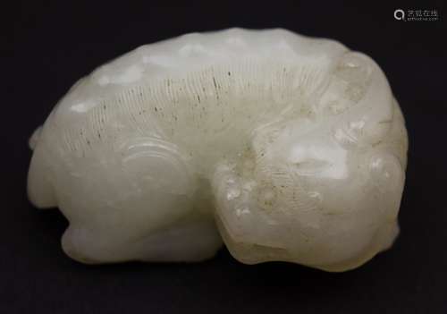 Jade carving. China. 19th century. Pure white stone with small black markings. Carving of a Pi Hsieh mythical animal. 2-1/4