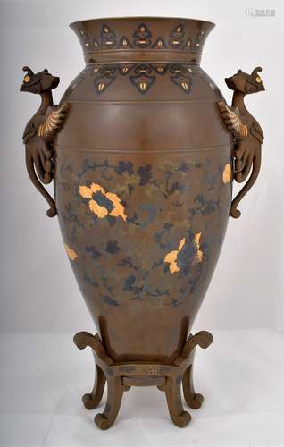 Mixed metal vase and stand. Japan. Meiji period (1868-1912). Phoenix handles. Decoration of floral scrolling. Inlays of gold, shakudo and copper. 15-1/4