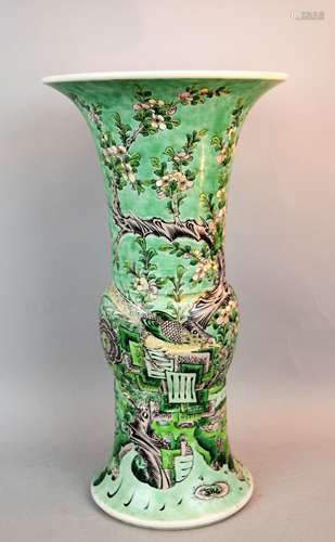 Beaker vase. China. 19th century, possibly earlier. Ku form biscuit with Famille Verte decoration of birds and flowering trees on a pale green ground. K'ang h si mark  in black on the base. Drilled and with two hairline cracks at the mouth. 15-3/4