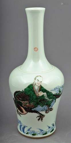 Porcelain vase. China. Late 19th century. Bottle shaped. Underglaze blue decoration with Famille Verte enamels of a Luohan and a dragon. K'ang hsi mark on the base. 11