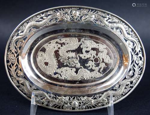 Chinese Export silver footed tray. 19th century. Oval shape. Pierced repousse border of dragons, pearls and clouds with the same engraved in the center. Signed TS and with a Chinese hallmark. 6-3/4