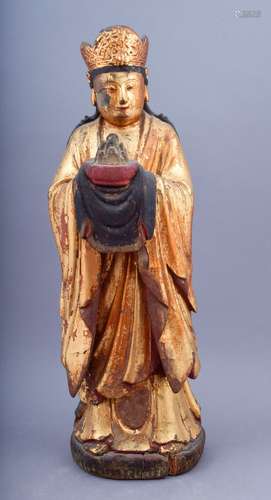 Wood carving. China. 18th century or earlier. Standing figure in a crown and flowering robe holding an offering. 20