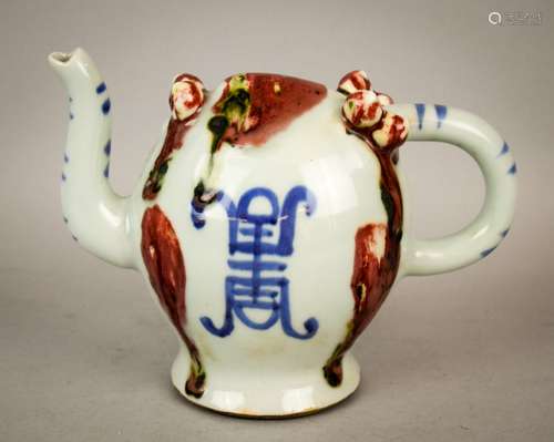 Porcelain wine pot. China. Early 20th century. Cadogan form.  Peach shape with underglaze blue and red decoration. 7-1/4