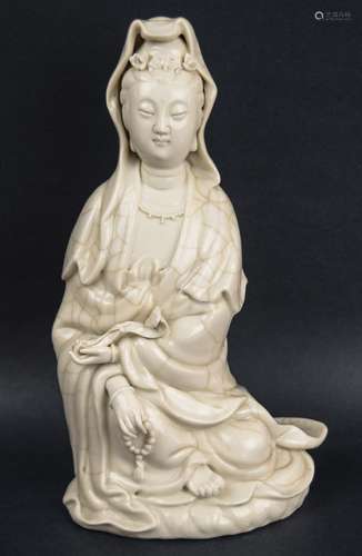 Porcelain figure. China. Late 19th century. White glaze with crackle controlled to decorate the robe only. Figure of The Goddess or Mercy. Kuan Yin. Signed. 11