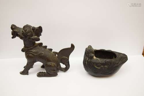 Two Bronzes. A Ming period (1368-1644) Kyline and a duck shaped water coupe with a Ch'ien Lung mark. 4