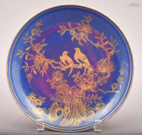 Porcelain saucer dish. China. 20th century. Blue monochrome with gilt decoration of birds in a flowering tree. Ch'ien Lung mark. 8-1/2