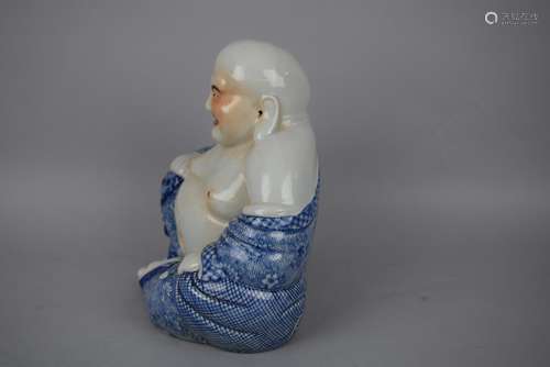 Porcelain figure. China. Early 20th century. Mi Lo Fo with underglaze blue robes and slight red accent. Makers mark on the base. 8-1/2