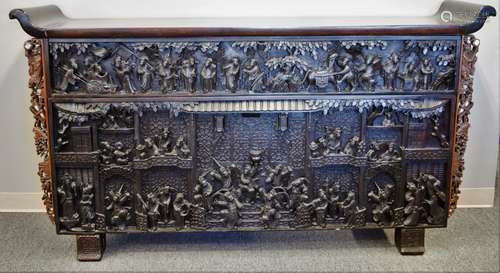 Altar table. China. 19th century. Rosewood. Front entirely carved with figure in a palace garden. Side panels inlaid with mother of pearl. 76