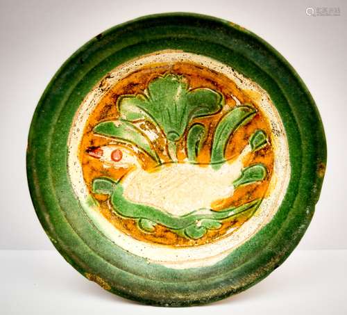 Stoneware saucer. China. Liao (907-1168). Scrafitto decoration of a duck in a lotus pond. Glaze of green, white and yellow. 5