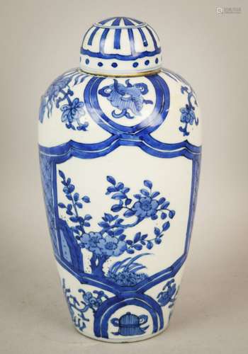 Porcelain covered jar. China. 20th century. Ovoid form. K'ang hsi style decoration of flowers and brocade patterns. 9-1/4