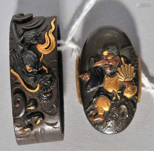 Fuchi-Kashira set, Japan. 18th century. Copper with Mixed metal inlays of gold Shakudo and Shibuichi. Decoration of a Tingu and a dragon. Signed.