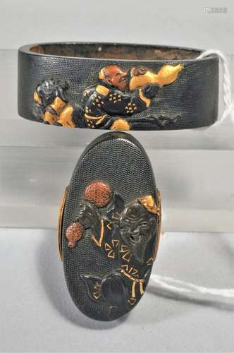 Set Fuchi-Kashira, Japan. 18th/19th century. Signed. Copper with mixed metal inlays of gold and shakudo with sennins. Signed and with a kakihan.