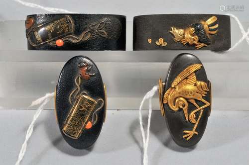 Two sets, Fuchi-Kashira, unsigned. Japan. 18th/19th century. Copper with shakudo, gold and silver. One with a design of a crane and chickens, the other with inro and netsuke with coral ojune.