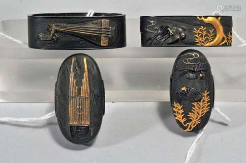 Two sets, Fuchi-Kashira,Japan. 18th/19th century. Unsigned. Copper with mixed metal inlay of gold and shakudo on nanako grounds. Decoration of musical instruments and willow trees and swallows.