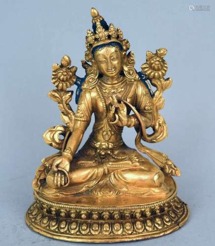 Gilt bronze image. Tibet. 18th century. Seated figure of the Green Tara on a double lotus throne. 5 h.