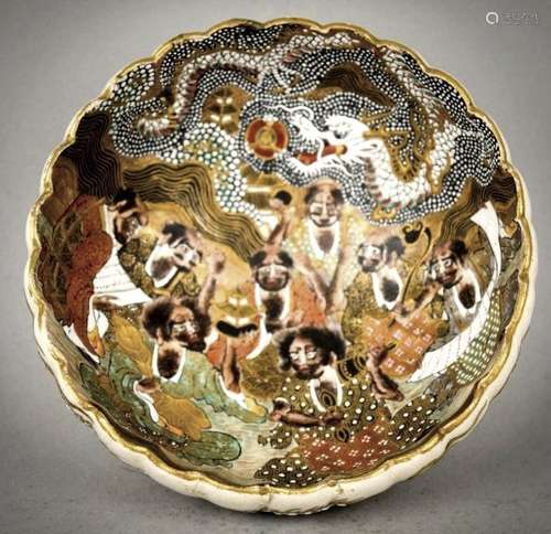 Pottery bowl. Japan. Meiji period. (1868-1912) Satsuma ware. Lobated form. Interior decorated with Rakans and a dragon. Exterior with white dragon. Signed Gyokuzan. 4