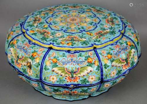 Peking enameled sweet meat box. China. Ch'ien Lung period (1735-1796). Lobated form. Sky blue ground with polychrome decoration of butterflies, flowers and resonance stones around a central stylized open flower. Interior with shaped dishes of a darker blue ground decoration with bats, shou characters and floral scrolls. (chips with enamel loss). 14