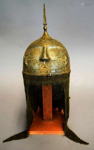 Helmet. Persia. 19th cent. Steel. Kulakhud with demon mask. Surface inlaid with gold. Spiked top. Chain mail neck guard.