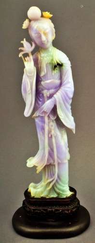 Jade carving. China. 19th century. Stone of deep lavender colour with apple green markings. Standing figure of a woman holding a flower. 10-1/2