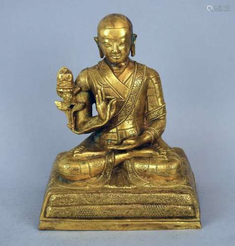 Gilt bronze image. Tibet. 18th century. Seated figure of high lama with a boddhisatva lineage emblem. Surface finely engraved. 6-1/2