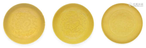 Three yellow-glazed incised 'dragon' saucer-dishes