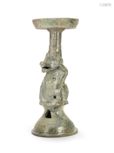 A green-glazed pottery 'bear' lampstand