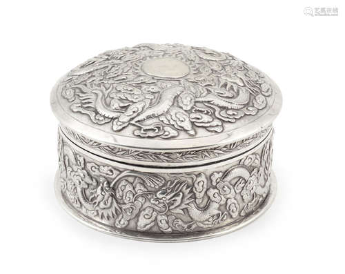 A circular silver 'dragon' box and cover